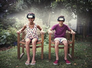 Mixed race children watching virtual reality screens