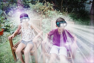 Mixed race children watching virtual reality screens
