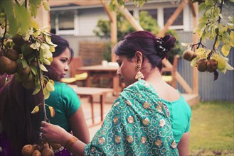 Women wearing Indian dresses in backyard