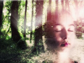 Double exposure of face of Mixed Race girl in forest