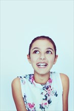 Portrait of smiling Mixed Race girl with big eyes