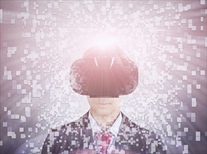 Mixed Race boy wearing suit using vr goggles
