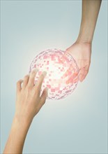Hands of Mixed Race boy holding glowing pixel sphere