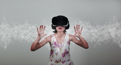 Mixed Race girl wearing virtual reality goggles