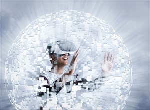 Fiji Indian boy wearing virtual reality goggles in floating sphere