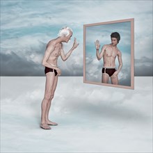 Older man admiring image of younger man in virtual mirror