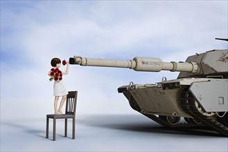 Girl placing flowers in gun barrel of tank
