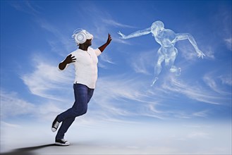 Man wearing virtual reality helmet reaching for fling spirit