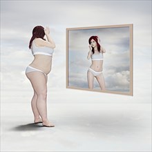 Overweight woman and reflection of skinny woman in the mirror