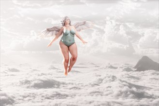 Overweight angel flying in clouds