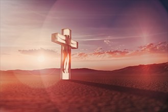 Person in suspended animation inside crucifix in desert