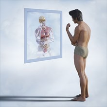 Men examining reflection of organs in virtual mirror