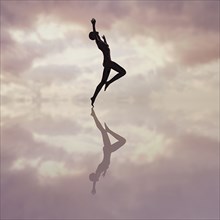 Reflection of woman dancing in cloudy sky