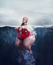 Underwater review of overweight woman swimming