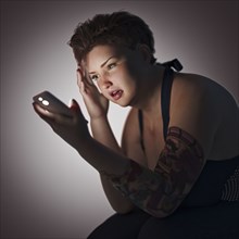 Overweight woman texting on cell phone