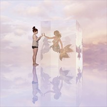 Woman standing near mermaid in cube