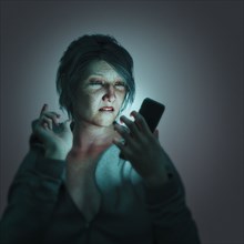 Frustrated woman texting on cell phone