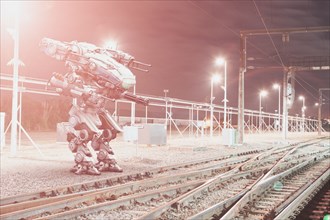 Robot aiming guns at railroad tracks