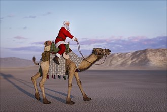 Santa riding camel in desert