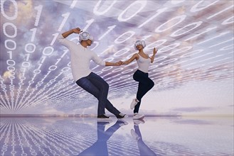 Couple wearing virtual reality helmets dancing in binary code