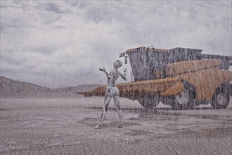 Robot looking up at rain in desert