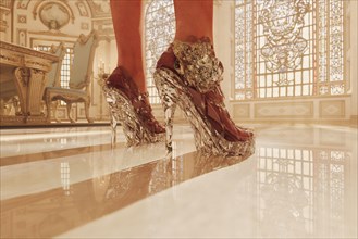 Feet of woman wearing clear high heel shoes