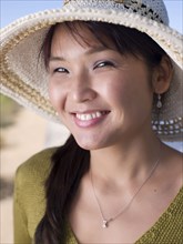 Asian woman in hat smiling