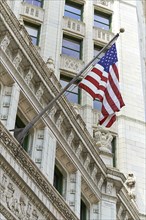 American flag hanging from ornate building