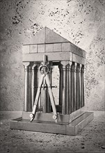 Silver model of pillars and archway with compass