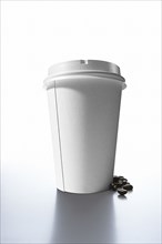 Coffee beans and paper cup