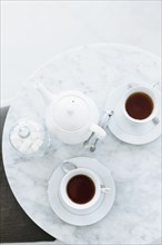 High angle view of cups of coffee on table