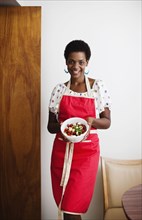 African American woman holding a bowl of salad