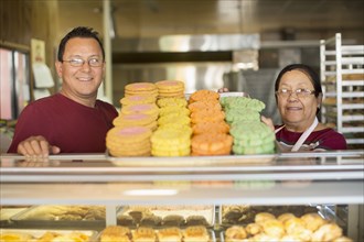 Hispanic bakers smiling in kitchen