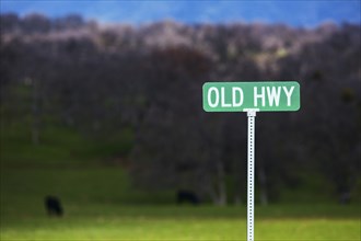 Old Hwy sign in rural landscape