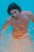 Caucasian man standing in pool