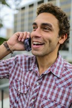 Hispanic man talking on cell phone