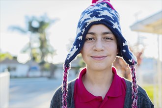 Hispanic boy wearing knit cap outdoors