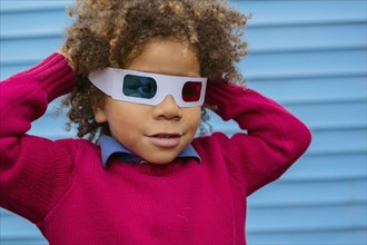 Pacific Islander boy wearing 3D glasses