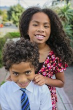 Pacific Islander brother and sister smiling outdoors