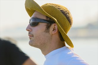 Caucasian man wearing sun hat and sunglasses