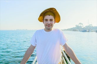 Caucasian man wearing sun hat on pier