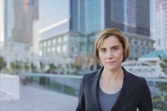 Caucasian businesswoman standing in city