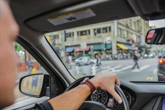 Caucasian man driving car in city