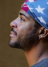 Profile of mixed race man wearing American flag turban