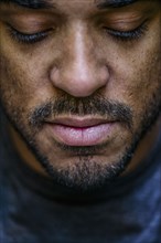 Close up of face mixed race man looking down