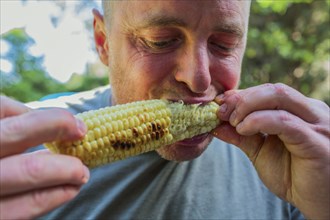 Close up of man eating corn on the cob