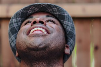 Close up of smiling Black man looking up
