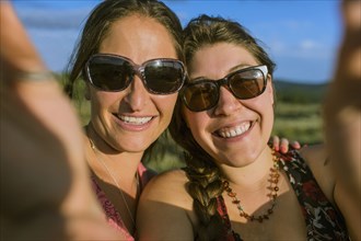 Caucasian women in sunglasses taking selfie