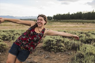 Caucasian woman posing in remote field