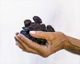Caucasian woman holding prunes